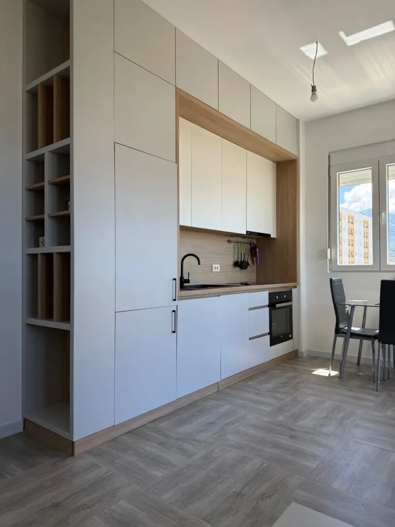 Modern kitchen with built-in cabinetry and a dining table.