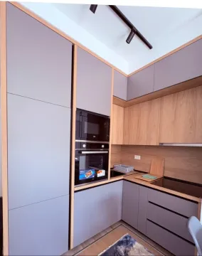 Modern kitchen with built-in cabinetry and appliances. - image 5