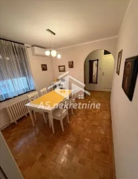 Dining area with dining table and chairs, parquet flooring and a passage to the hallway. - image 7