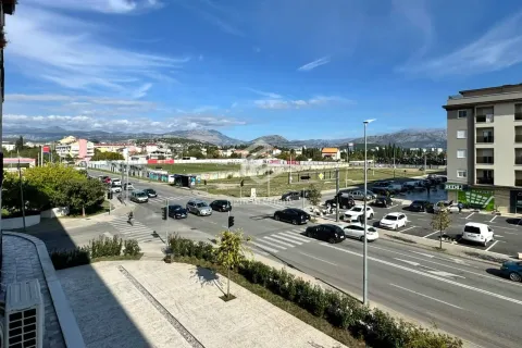 View from the terrace overlooking the city street, parking lot, and surrounding mountains. - image 18