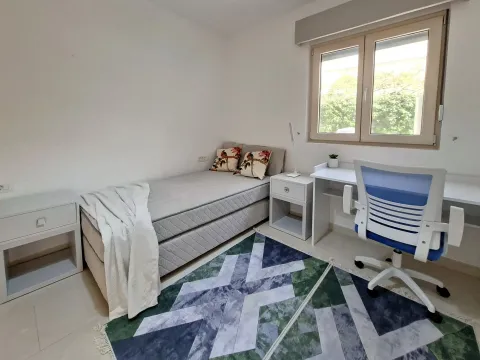 Manja spavaća soba sa krevetom, radnim stolom i prozorom. - image 2