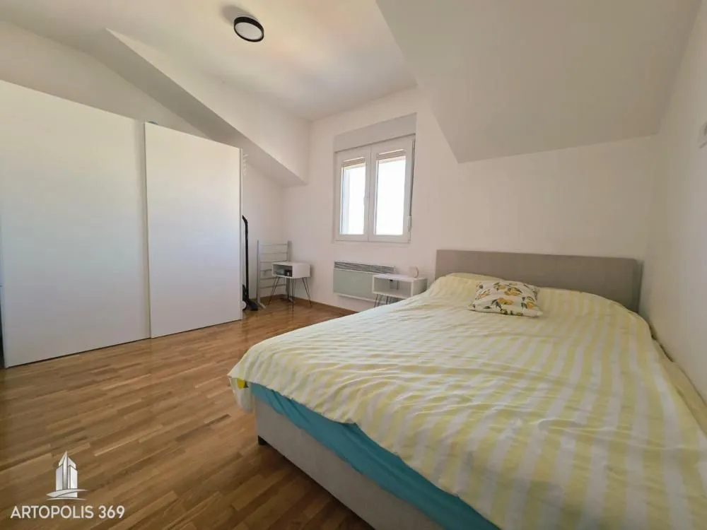 Bedroom with a double bed, large wardrobe, and a window.