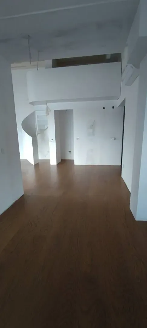 Prazan dvoetažni stan sa drvenim podom.
