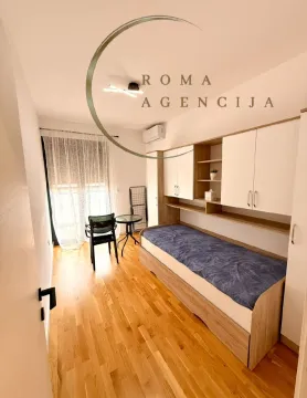 Smaller bedroom with a bed and fitted wardrobe. - image 7