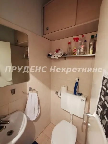 Small bathroom with a sink, toilet, and wall cabinet.