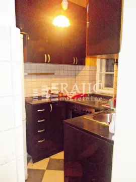 Small kitchen with dark cabinets and a sink. - image 8