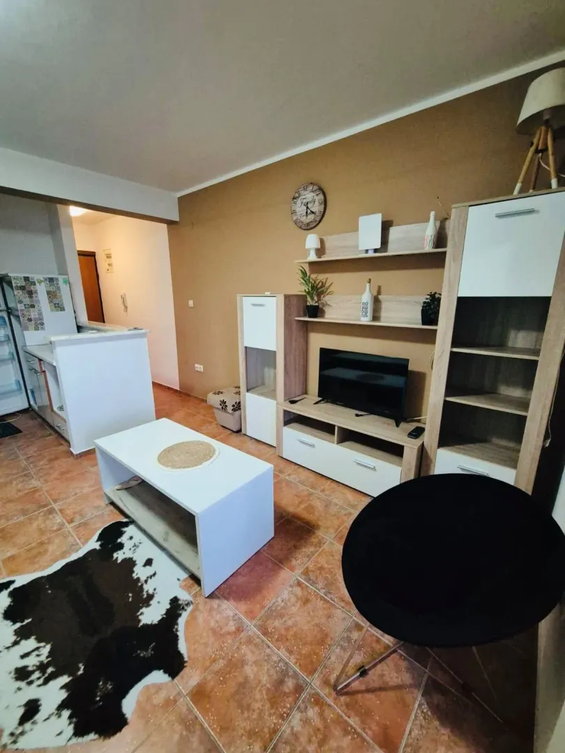 Furnished living room with TV unit and coffee table.