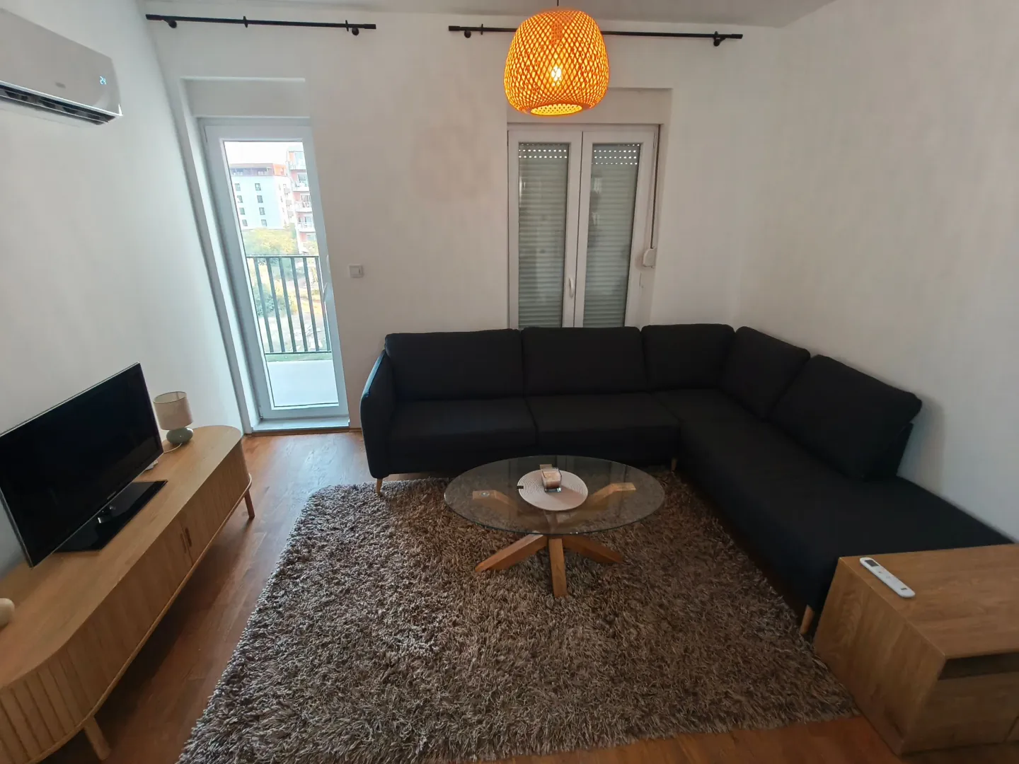 Living room with a sectional sofa, coffee table, and TV.