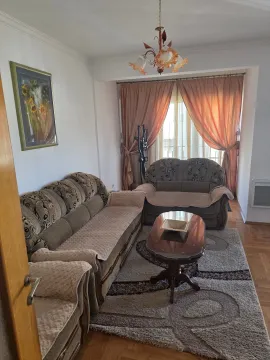 Living room with a sofa set, coffee table, and curtained window. - image 3