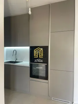 Modern kitchen with built-in cabinetry and a sink. - image 8