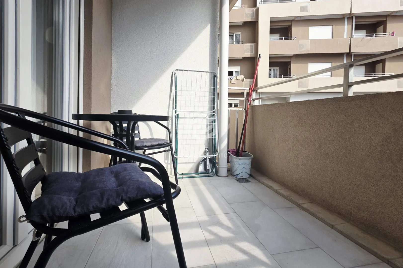 Furnished balcony with a table and chairs.