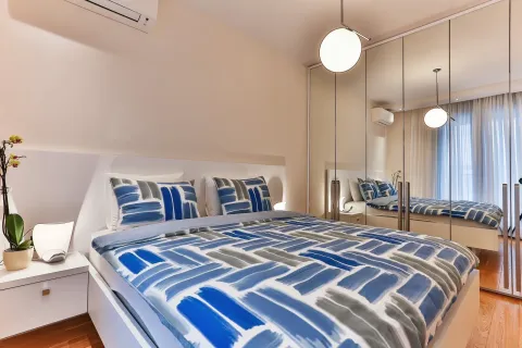 Bright bedroom featuring a double bed and a built-in mirrored wardrobe. - image 4
