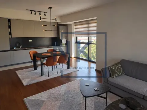 Open-plan living room with dining area and kitchen. - image 4