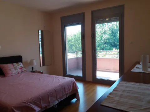 Bedroom with a double bed and access to the terrace. - image 5