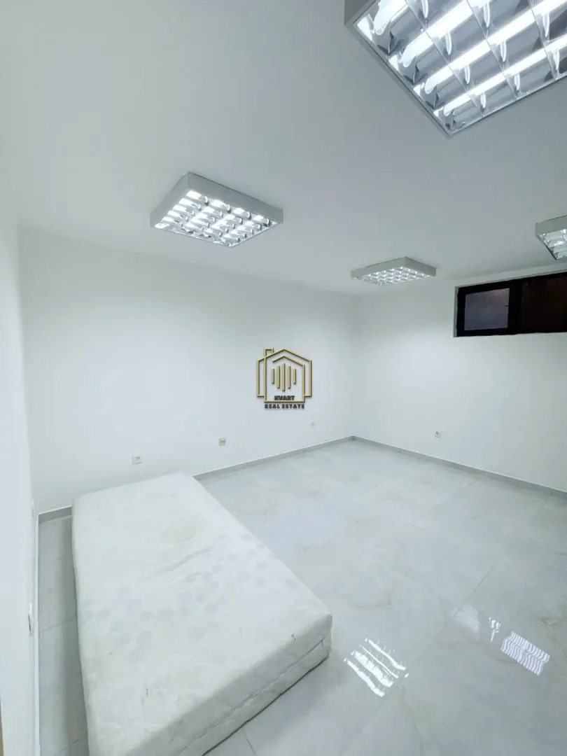 Empty room with white walls, tiled floors, and a mattress on the floor.