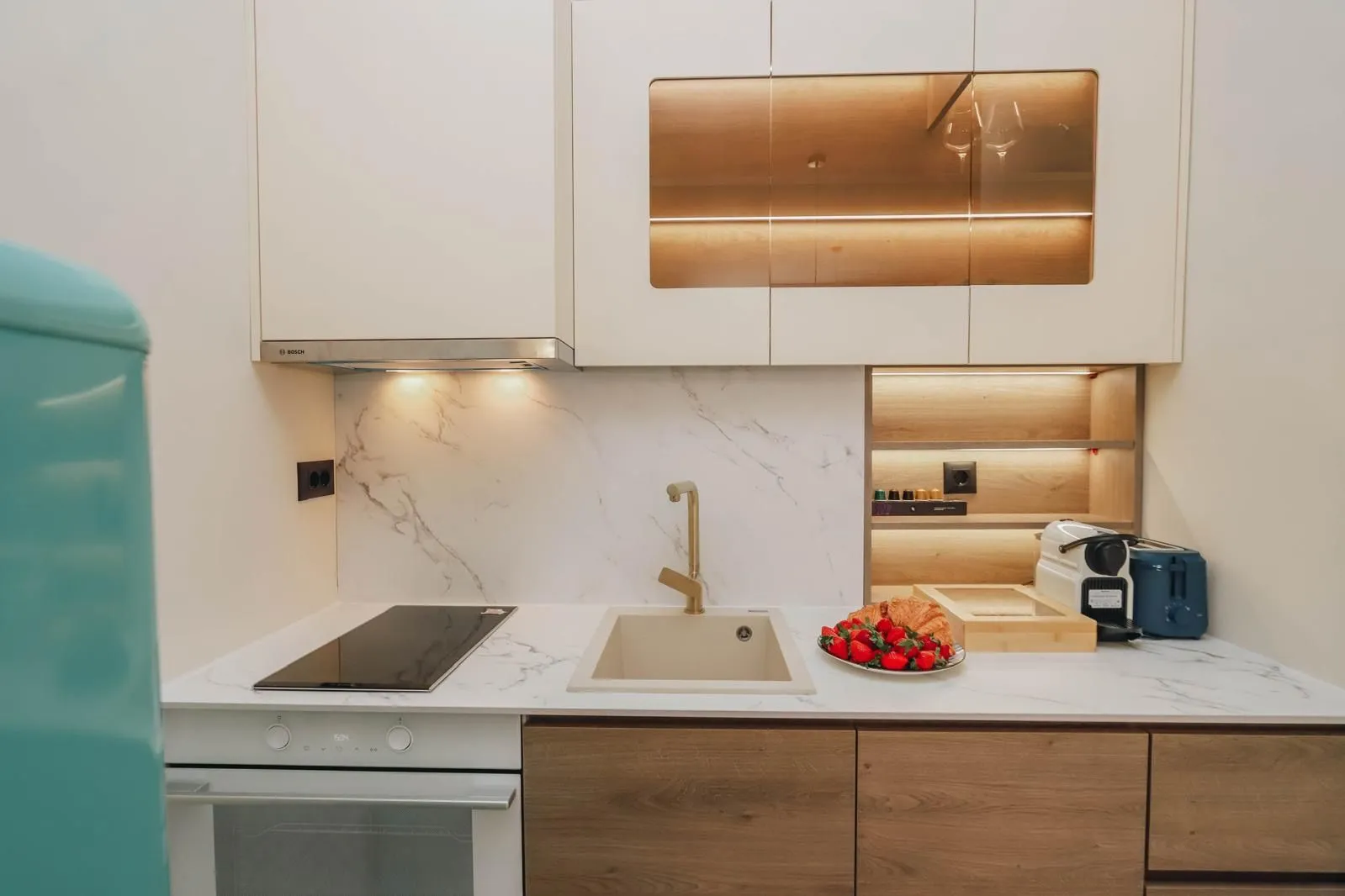 Modern kitchen with white and wooden elements.