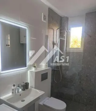 Modernly equipped bathroom with a walk-in shower and washbasin. - image 6
