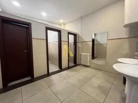 View of a bathroom section with sinks and tiling. - image 8