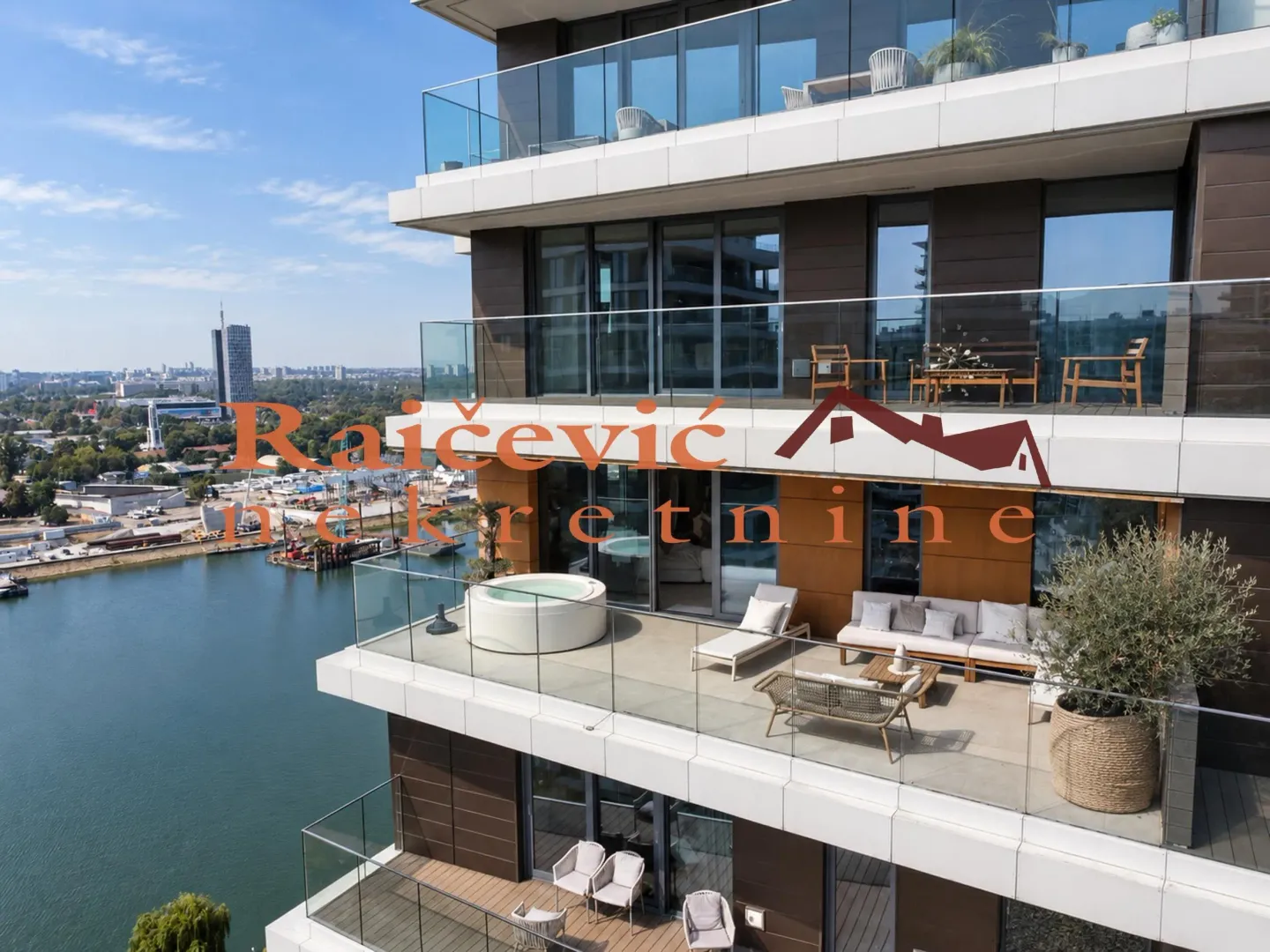 Exterior view of a modern residential building with spacious terraces and a river view.