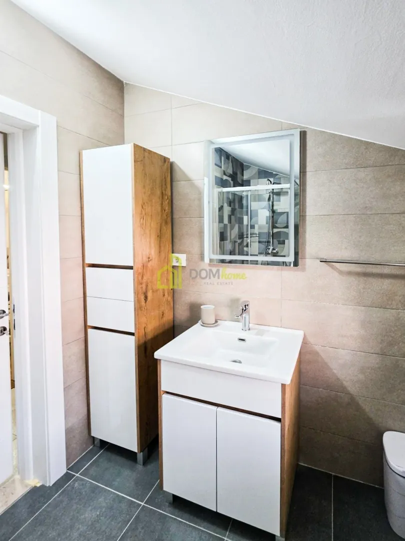 Modern bathroom with a sink, cabinet, and mirror.