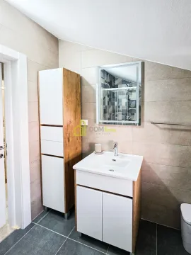 Modern bathroom with a sink, cabinet, and mirror. - image 2