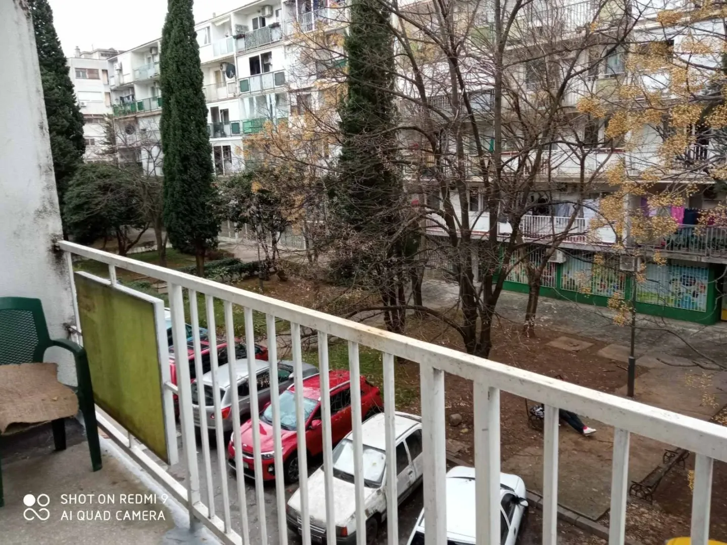 View from the balcony overlooking the courtyard and neighboring residential buildings.