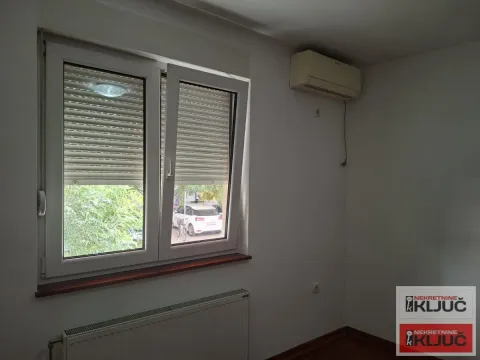 Prazna soba sa prozorom, radijatorom i klima uređajem na zidu. - image 4