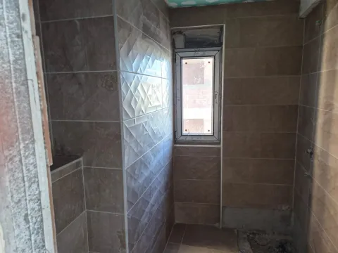 Bathroom during final ceramic installation work with a window. - image 31