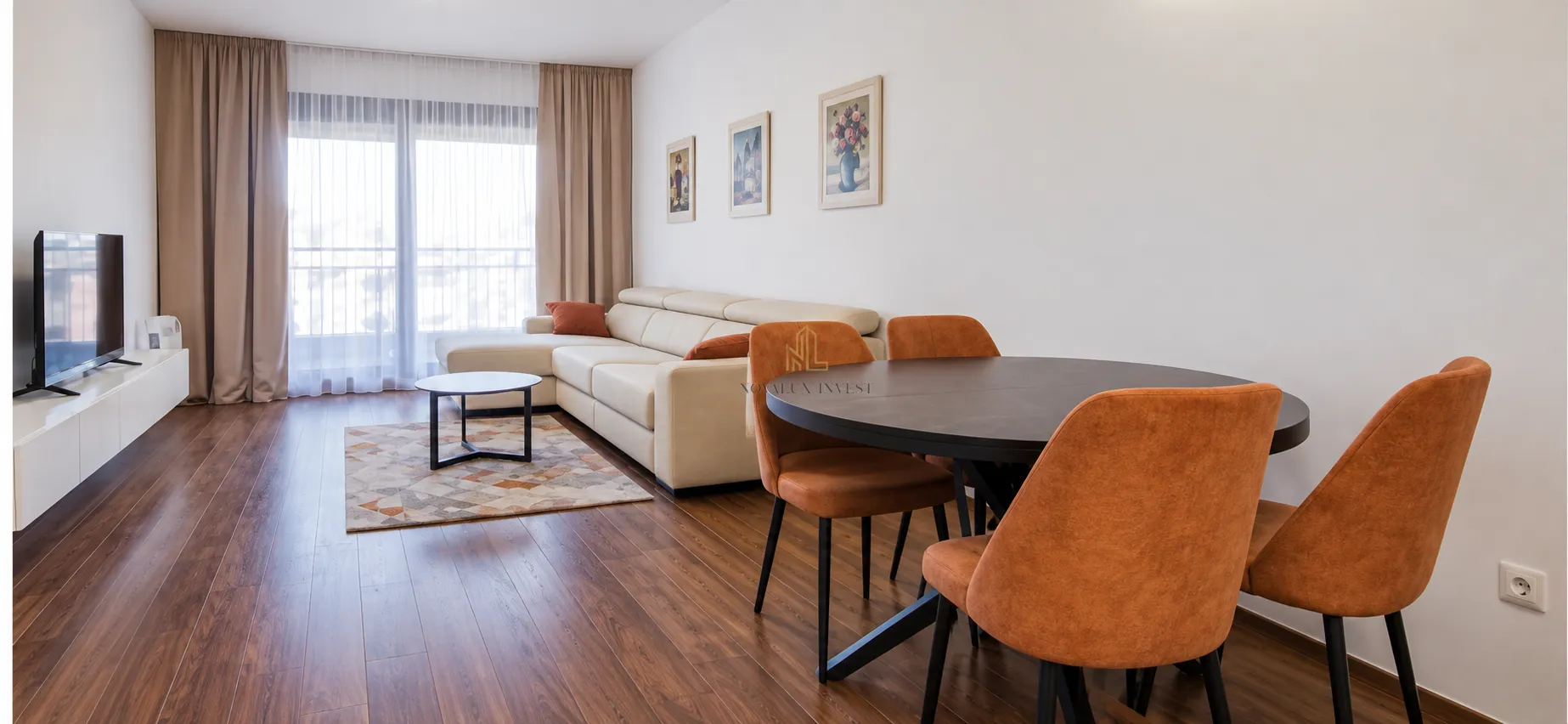 Spacious living room with a sofa set, dining table and TV.