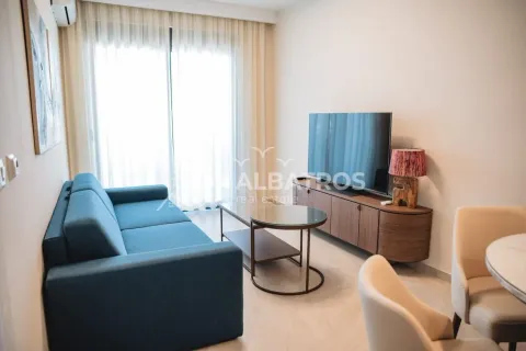 Living room with a blue sofa, TV, and access to the terrace. - image 5