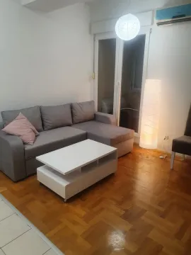 Bright living room with a grey corner sofa and a white coffee table. - image 2