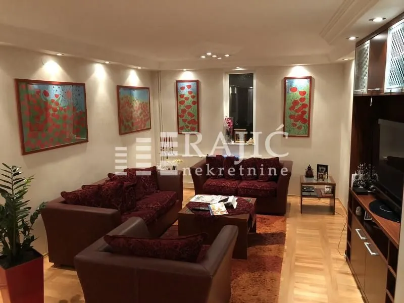 Living room with a sofa set and wooden furniture.