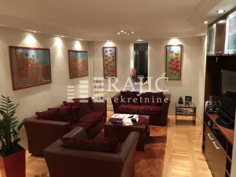 Living room with a sofa set and wooden furniture. - image 4