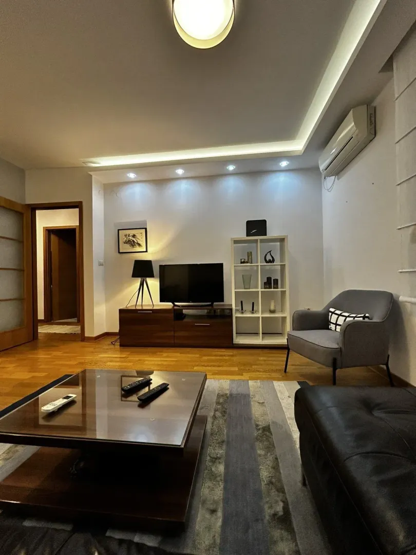 Living room with a TV stand and coffee table.