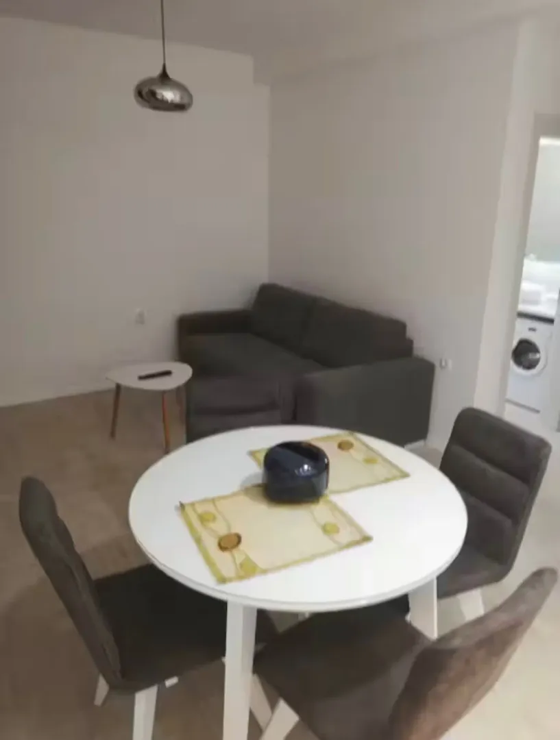 Living room with a dining table and sofa.