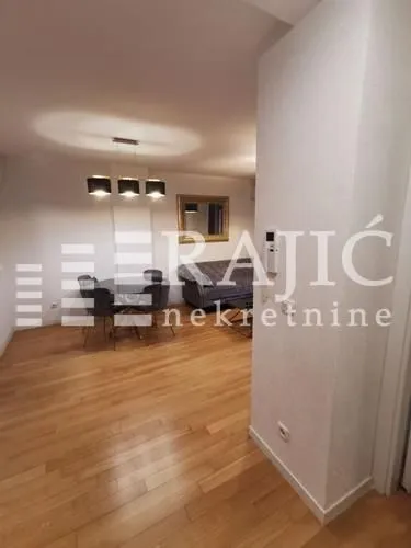 Living room with dining area and wooden flooring.