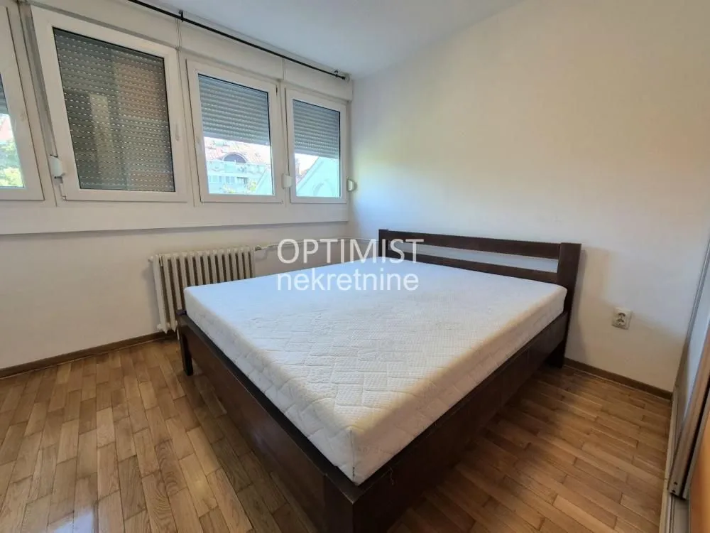 Bedroom with a double bed and wooden flooring.