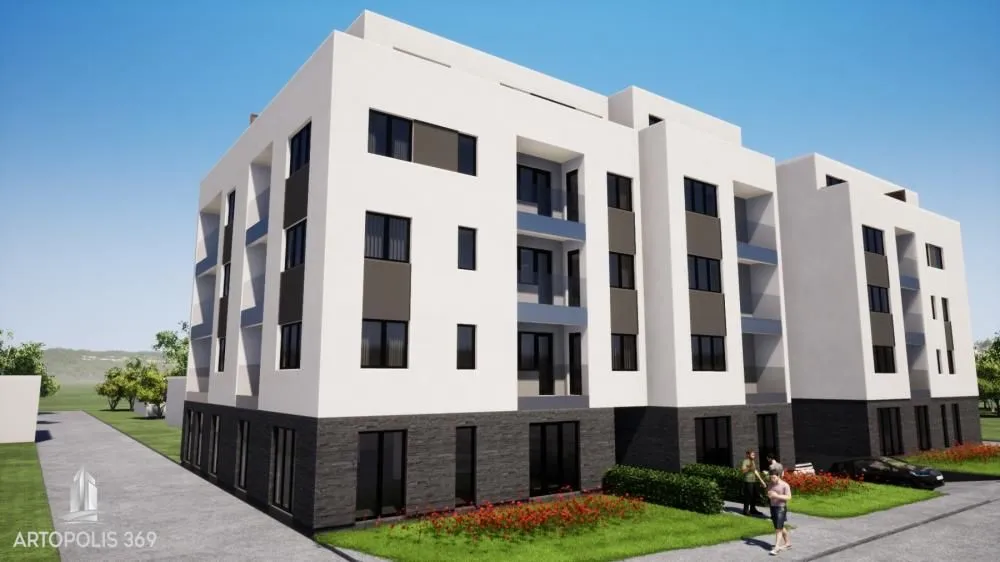 Spoljašnji izgled moderne stambene zgrade sa uređenim dvorištem.