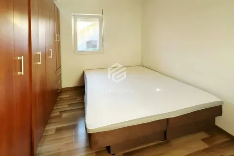 Furnished bedroom with a double bed and a large wooden wardrobe. - image 4