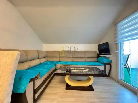 Living room with a sectional sofa and a coffee table in the attic. - image 3