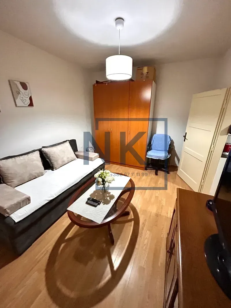Living room with a sofa, coffee table, and wardrobe.