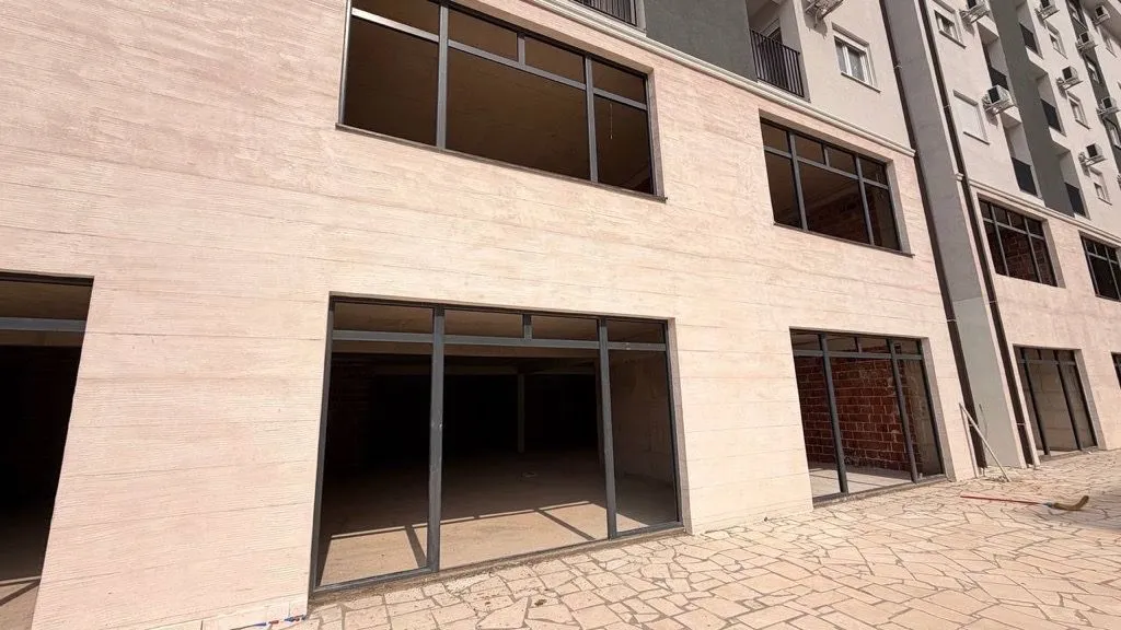 Exterior of the commercial space on the ground floor of a new residential building.