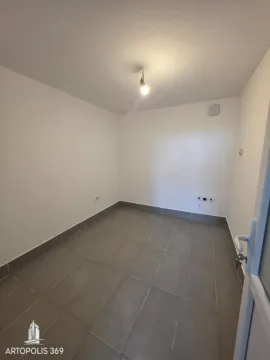 An empty room with gray floor tiles and white walls. - image 11
