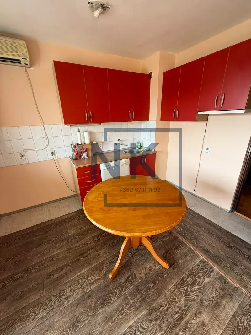 Kitchen with red cabinets and a round dining table.