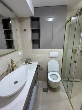 Modern bathroom equipped with a shower cabin, washbasin, and wall cabinets. - image 14