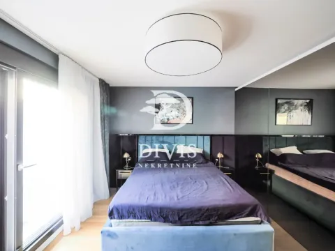 Modern bedroom with a double bed, dark accent wall, and a large mirror. - image 10