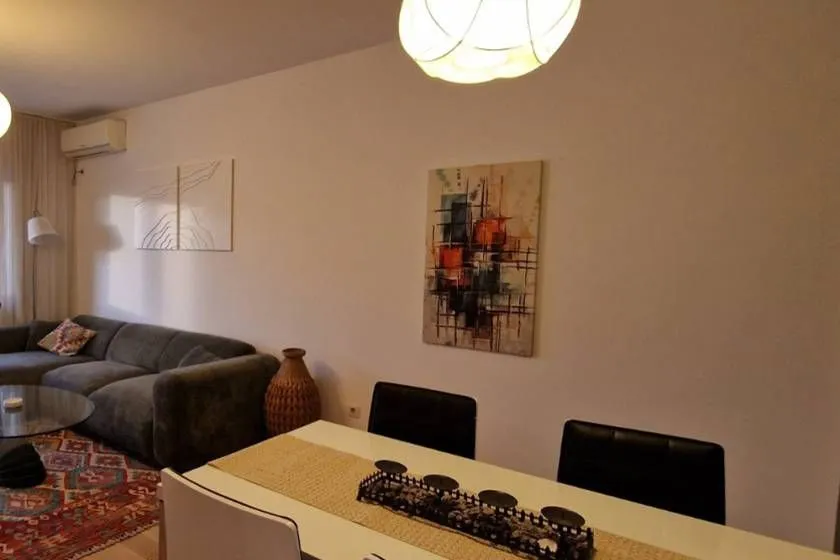 Living room with a sofa set and a dining table.