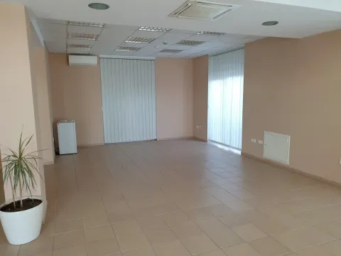 A spacious empty room with tiled flooring, suitable for an office or commercial space. - image 13