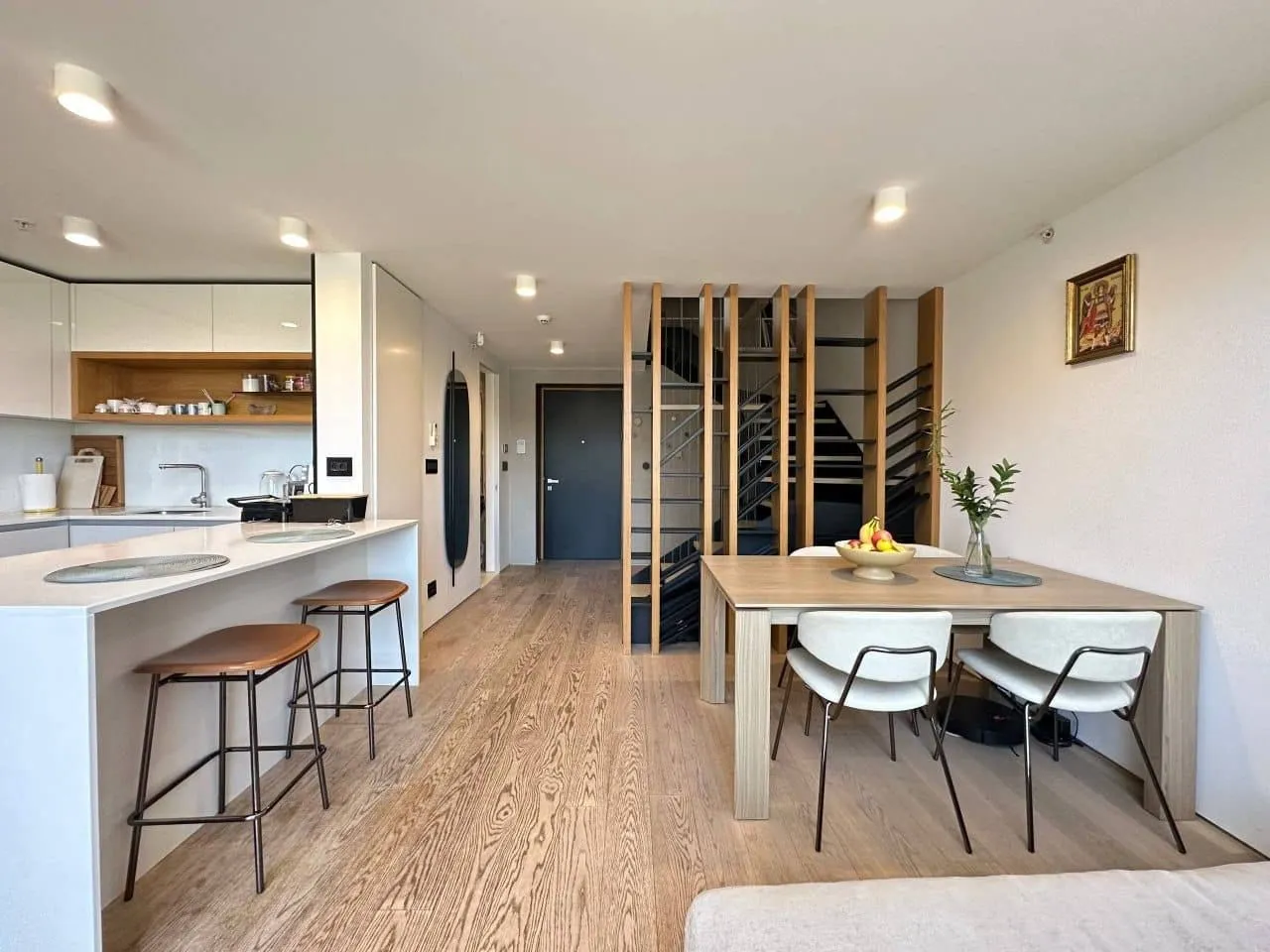 Modern living room interior with a dining area and kitchen.