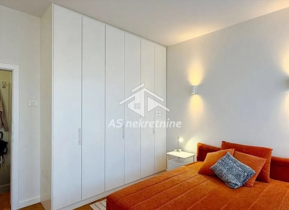 Bedroom with a double bed and a large built-in wardrobe.